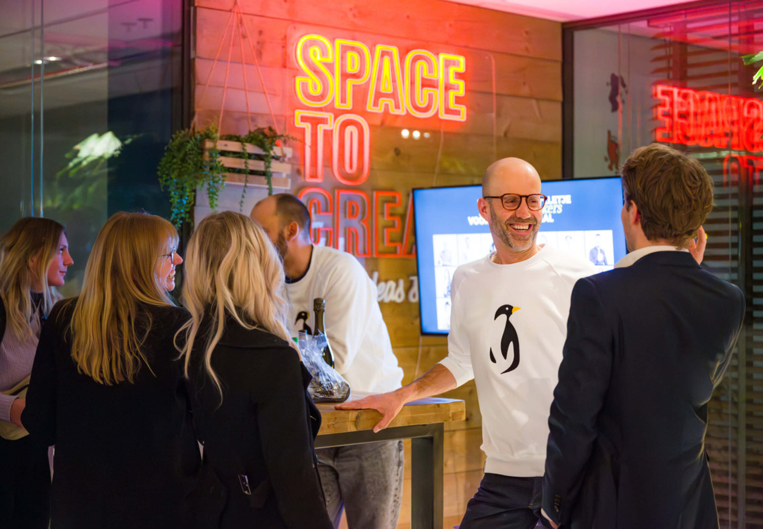 People standing around a table laughing