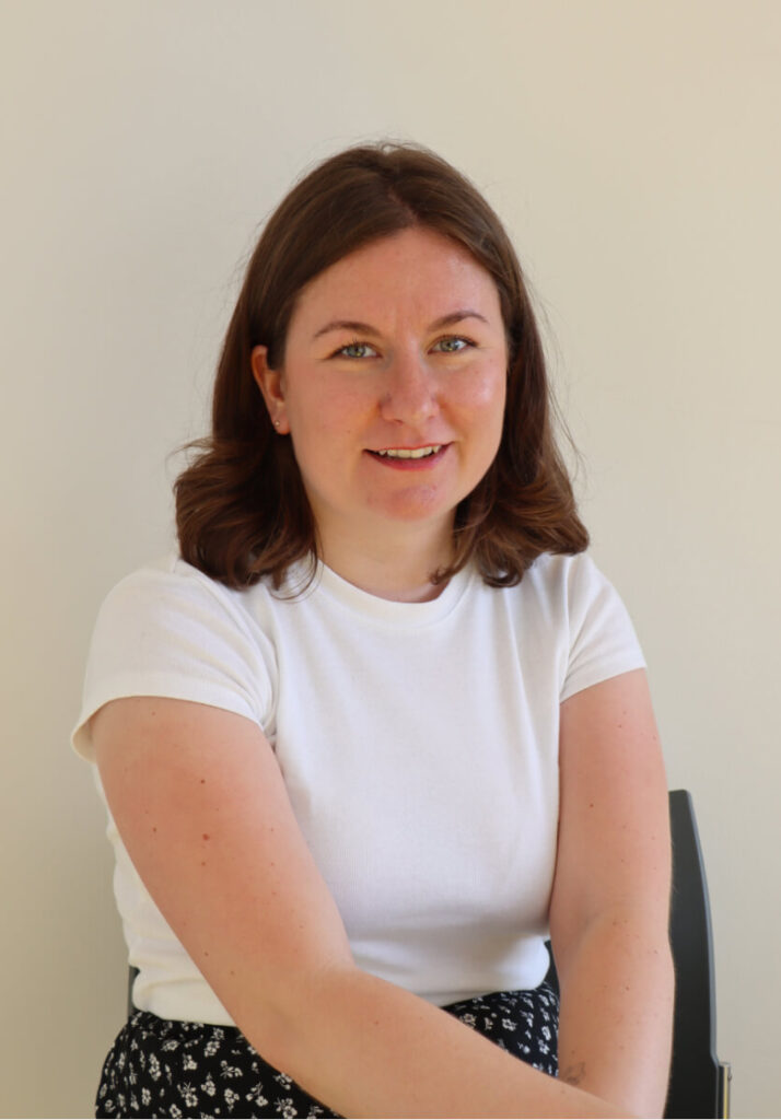 Portrait of David Geha, wearing a white t-shirt posing for the picture.